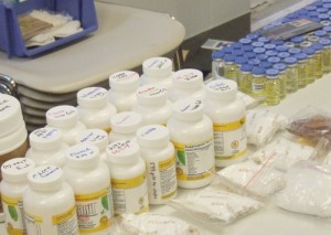 Frank Denzler The Rushville Republican Pictured are some of the items seized during a multi-departmental effort Tuesday morning at a Rush County residence. The vials (rear right) are believed to be anabolic steroids that sell on the street for upwards of $120 each.